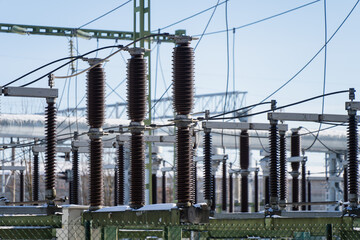 Electric transmission yard with rows of insulator stacks, cables and metal frames, critical energy infrastructure and industrial safety concept background