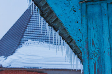 Icicles on the roof of the house. Danger of falling