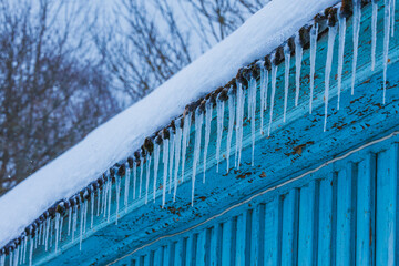 Icicles on the roof of the house. Danger of falling