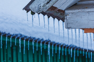 Icicles on the roof of the house. Danger of falling