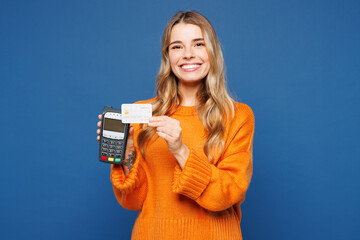 Young happy woman she wear yellow sweater casual clothes hold wireless modern bank payment terminal...