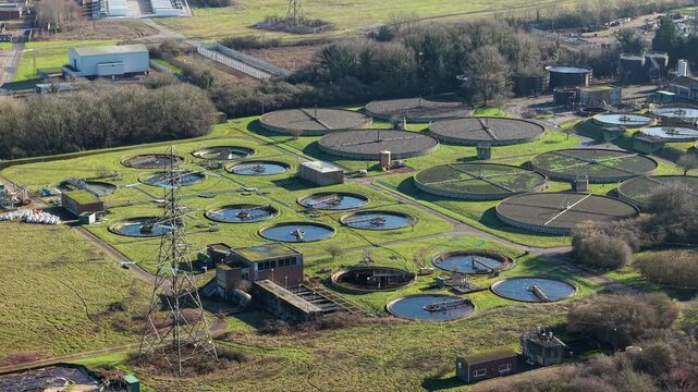 Aerial view of a large wastewater treatment plant with circular ponds in Luton UK