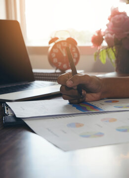 Business and Financial Planning Concept. Financial advisor planning and working on laptop. Professional Businesswoman discusses and review annual report at office-vertical image