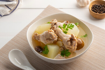 Winter Melon with Chicken wings (drumettes) and preserved lime soup in white bowl.Thai food.