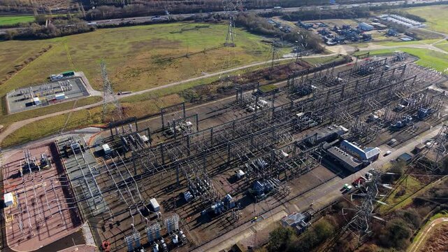 The Great Grid Upgrade aerial view of Sundon Supergrid substation near Luton UK featuring 400kV transformers and high-voltage pylons.