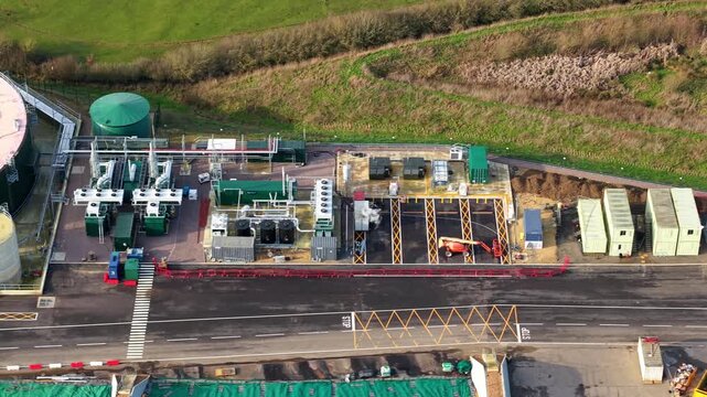 This close-up aerial perspective provides an intricate look at the mechanical heart of a biogas facility. By focusing on the functional components like cooling fans and heat exchangers, the footage em