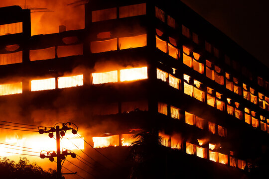 Chattogram, Bangladesh - 16 October 2025: View of a building engulfed in flames, the dark night sky contrasting sharply with the intense orange glow of the fire..