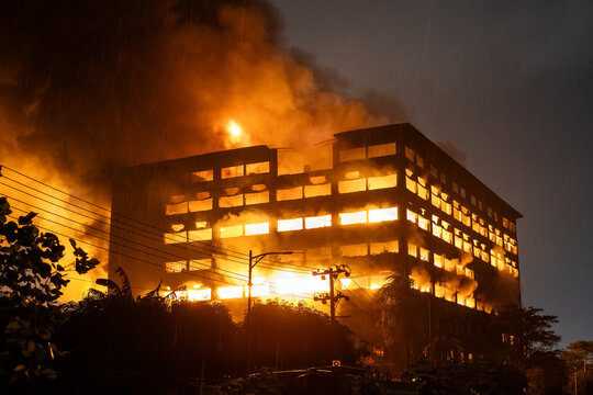 Chattogram, Bangladesh - 16 October 2025: View of a building engulfed in flames, casting a fiery glow against the dark sky.