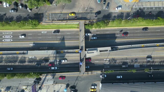 Straight down aerial perspective of intense traffic flow at the Metropolitano bus station in Lima, South America.