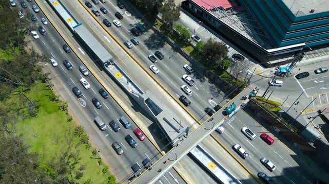 Aerial flight over Metropolitano station along Via Expresa with views of Lima city skyline, Peru 4K 60fps drone footage.