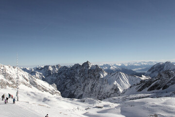 Panoramic view of the snowcovered alps in bavaria europe germany under a blue sky from german mountain Zugspitze