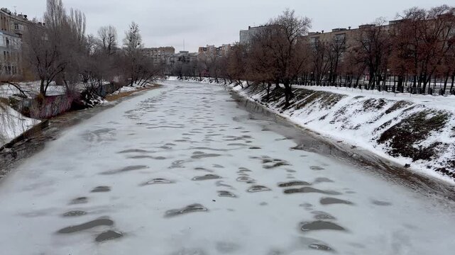 The river is covered with ice in the city center