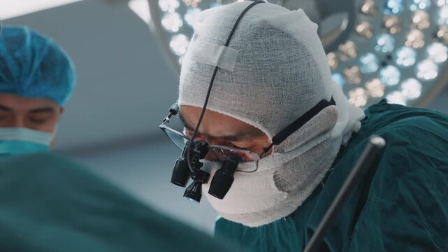 Close-up surgeons performing an operation with medical instruments under sterile conditions. Professional healthcare teamwork transplantation plastic surgery. Professional medical team working in a