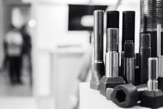 Close-up of steel bolts and screws in industrial workshop setting