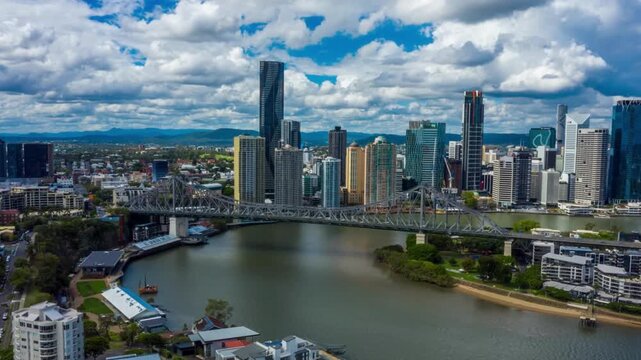 Breathtaking Time-lapse aerial shot of Brisbane skyline and Story Bridge. vibrant energy of the Brisbane River as shadows and light shift across the glass skyscrapers of the financial district. Queens