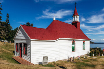 Fototapeta premium Tadoussac, Canada - August 22, 2025: Chapelle de Tadoussac (Tadoussac Chapel), historic wooden church overlooking the St Lawrence River in Quebec