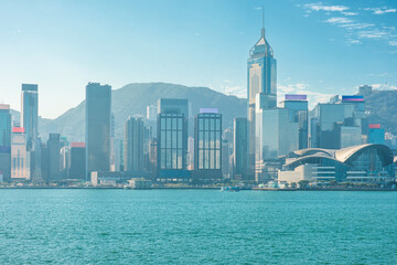 Obraz premium Hong Kong skyline along Victoria Harbour with modern skyscrapers and the Hong Kong Convention and Exhibition Centre, China. Global city, financial district, urban development, international business