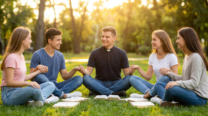 Fototapeta premium Youth Prayer Circle with Priest at Sunset