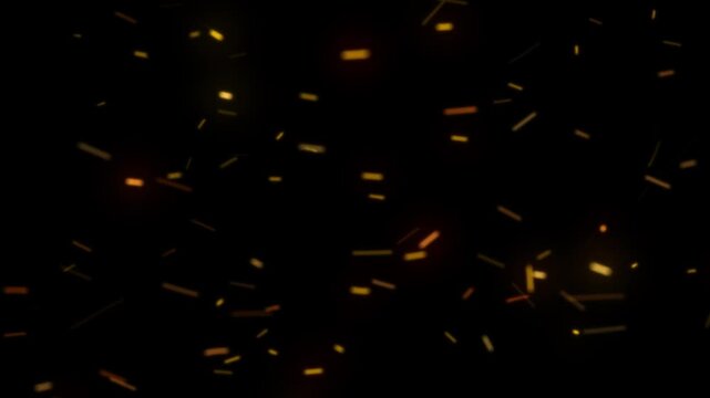 Flying orange sparks and embers on a dark background