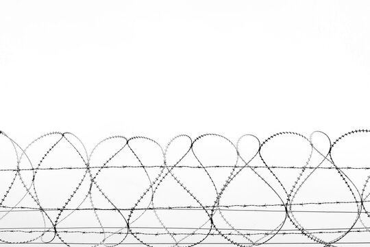 barbed wire against the blue sky