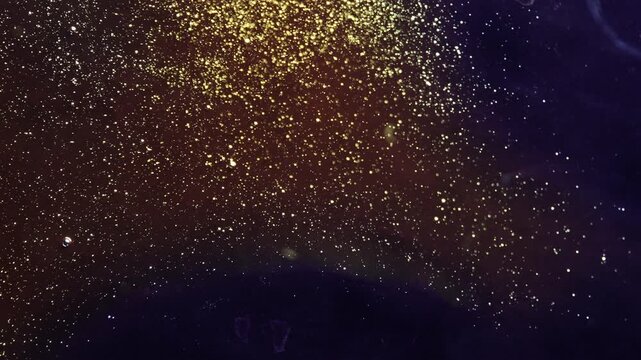 Abstract macro motion of tiny golden bubbles and glitter particles rising from the corner in dark liquid. Elegant fluid transitions with shimmering gold dust and organic shapes.