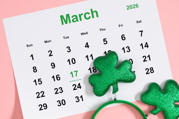 St. Patrick's Day 2026 calendar planner with green glitter shamrocks on pink background. March 17...