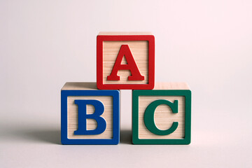 Wooden ABC alphabet blocks arranged for preschool learning. Сlassic educational cubes ideal for early childhood development, literacy concepts  and school-ready branding.