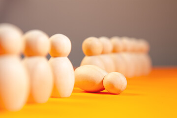 Business concept. Wooden figures of people standing in a row on an orange background.