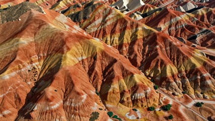 Aerial view of colorful danxia landform mountains with vibrant striped rock formations in china park