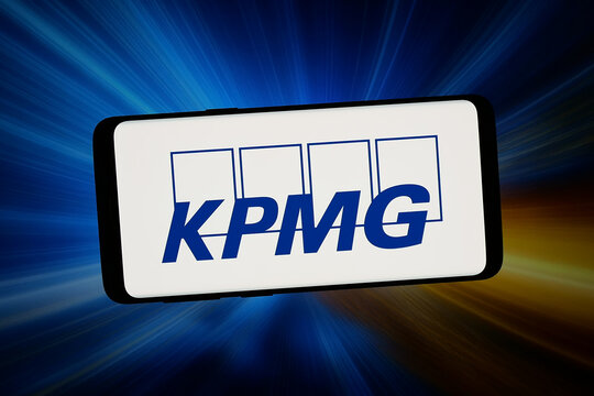 Stuttgart, Germany - 02-14-2026: In this photo illustration, the logo of consulting company KPMG International Limited is displayed on a smartphone in front of abstract background on computer screen.