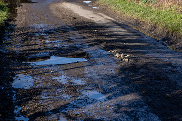 Pot holes on a country road in rural Sussex
