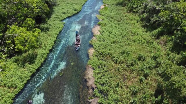 Aerial drone view of tourists on a boat tour in the crystalline Sucuri River in Bonito, Mato Grosso do Sul, Brazil