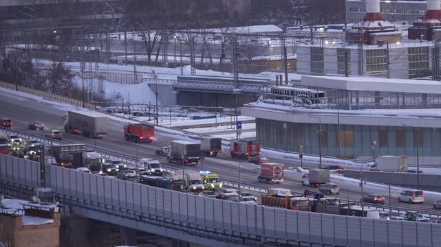Busy multilane highway with heavy traffic flow in winter urban environment, city transportation infrastructure, logistics and economic activity concept