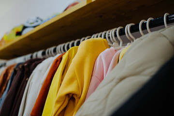 Sweatshirts for girls and boys. Children's clothing store. Clothes on hangers.