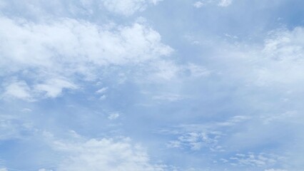 Obraz premium Clear blue sky with beautiful white clouds. Blue sky background featuring bright clouds. The sky appears full of soft fluffy clouds.