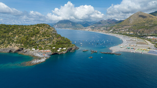 Aerial view of the Tyrrhenian coast of Calabria, Italy. In the background is the long beach of Praia a Mare, located in the Province of Cosenza. It is a sunny summer morning.