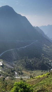 A scenic view of the Ma Pi Leng Pass in Quan Ba, Ha Giang, Vietnam. showcasing the winding road and mountainous landscape. Tourists visit to experience the natural beauty.