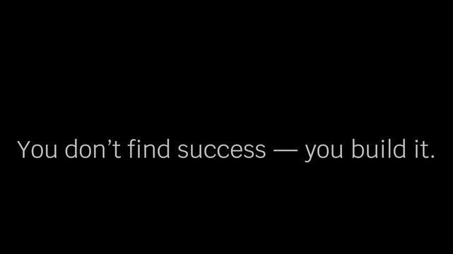 Motivational quote text stating 'You don't find success &mdash; you build it' displayed prominently against a deep black background for inspiration.