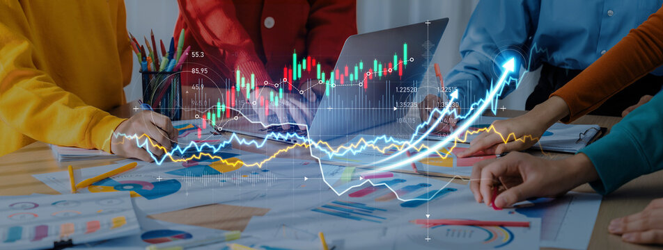 Professionals collaborate at a table, analyzing financial charts and graphs during a meeting focused on business strategies and data visualization techniques. Scalp