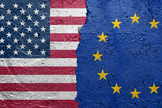 United States of America vs Greenland - Cracked concrete wall painted with a USA flag on the left and a Greenland flag on the right stock photo