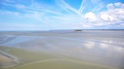 Tombelaine island rock in Mont Saint-Michel Bay, Normandy, France, Europe. Tombelaine island stands isolated on vast tidal flats in Mont Saint-Michel Bay, Normandy, France, Europe. © Iryna Shpulak