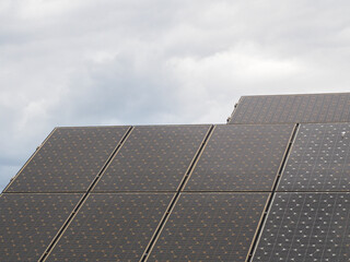 Solar panels cloudy sky. Renewable energy concept