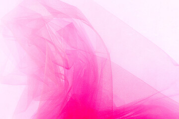 Bright pink tulle fabric background.  Abstract transparent material curve wave.