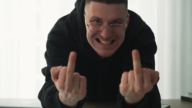 Against the rules.
A person protests by showing the middle finger.
An obscene finger gesture.