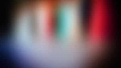 Abstract Blurred Background with Dark Vignette and Vertical Stripes in Red, Green, Black, and White.