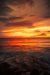 Dramatic Fiery Ocean Sunset with Waves and Colorful Cloudy Sky
