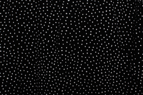 Black fabric with white polka dot pattern