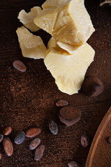 ingridients for truffles with natural cocoa beans,  powder, cocoa butter, cane sugar. healthy sweets concept. flat lay