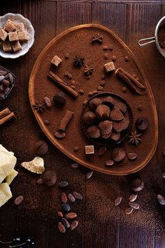 healthy delicious chocolate truffles around ingridients with natural cocoa beans,  powder, cacoa butter, cane sugar. healthy sweets concept. flat lay