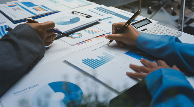 Auditor and accountant team working in office, analyze financial data and accounting record with calculator. Accounting company provide finance and taxation planning for profitable cash flow.